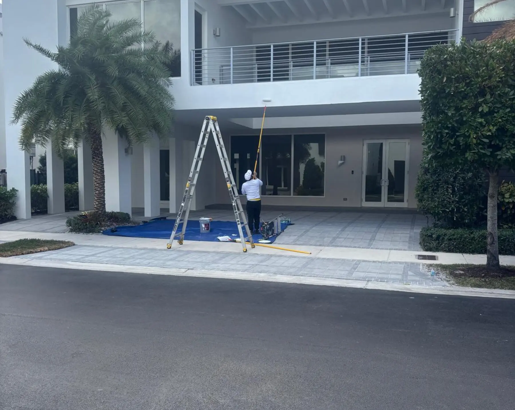 GXG Remodeling painter exterior painting a home in Homestead, FL