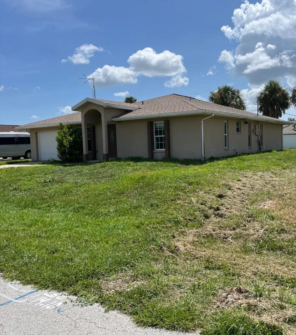 Homestead FL home exterior before repainting, tan stucco with dark trim