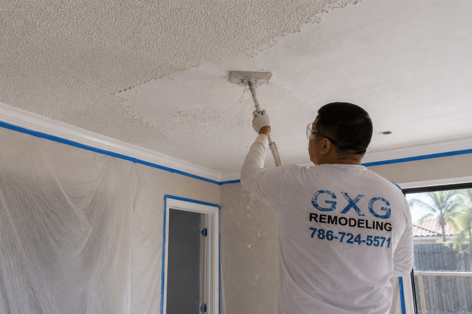 Professional contractor removing popcorn ceiling texture in a Homestead, Florida home using specialized ceiling scraping tools and protective coverings.